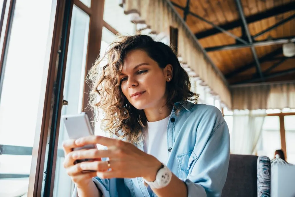 woman-sitting-on-phone-testing-mobile-app-design